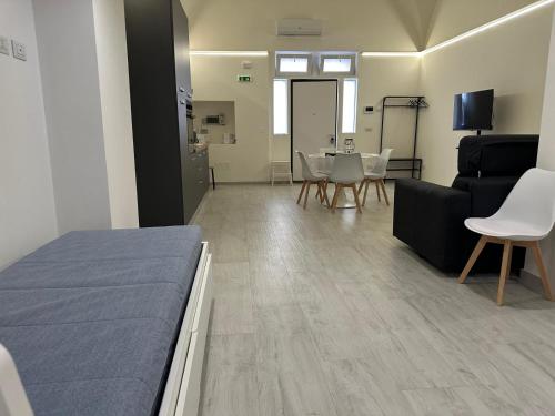 a room with a bed and a couch and a table at Saxlafenice in Bari