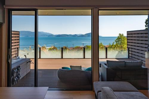 a living room with a view of the ocean at SETO CLAS for SLEEP B棟 in Takamatsu