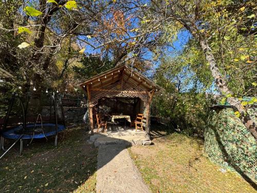 a gazebo in a yard with a table at Timur Resort Turgen in Taūtürgen
