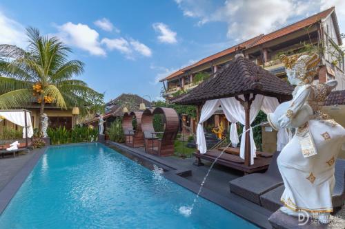 a swimming pool in front of a house at Pondok Kutuh Guest House in Ubud