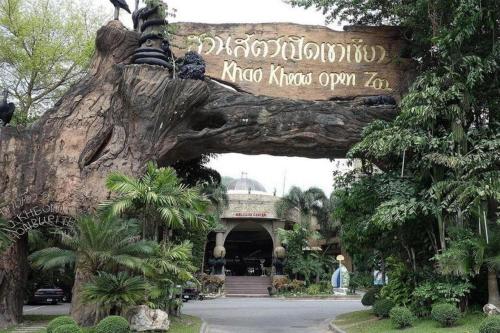 an entrance to the disneyland resort with a large tree trunk at Super OYO 662 Malee Bunga Hotel in Si Racha