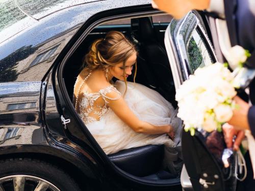 a bride sitting in the back of a car at Mercure Lyon Est Chaponnay in Chaponnay