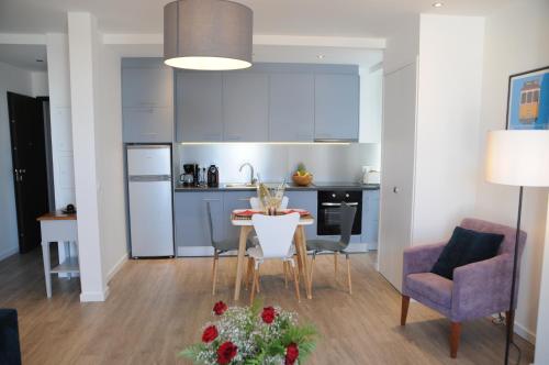 a kitchen and living room with a table and chairs at Lisbonne Appartements in Lisbon