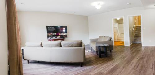 a living room with a couch and a table at entire house THE BLUE DOOR with garage access in Grande Prairie