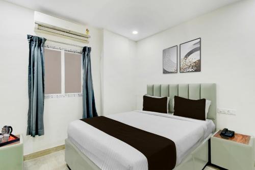 a bedroom with a bed and a window at Super Townhouse Nagole RTO Office in Upal