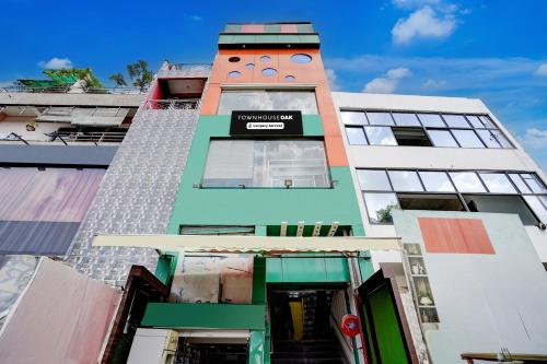 a tall building with a face on it at Super Townhouse Oak Prayagraj Central Railway Junction Formerly Hotel Ballians in Prayagraj