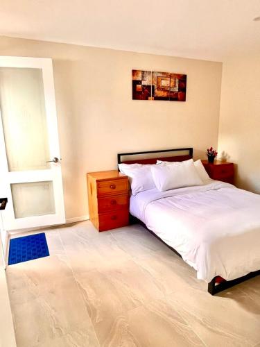 a bedroom with a bed and a dresser and a window at Bright & Quiet 1BR with Courtyard in Williams Landing