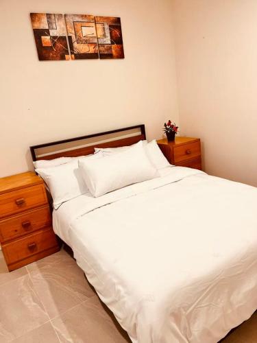 a bed with white sheets and pillows in a bedroom at Bright & Quiet 1BR with Courtyard in Williams Landing