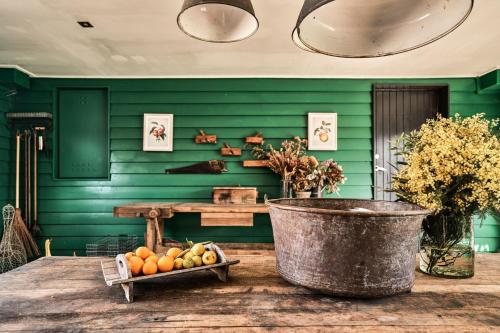 a room with green walls and a basket of fruit at Vale Hill House in Lawrence