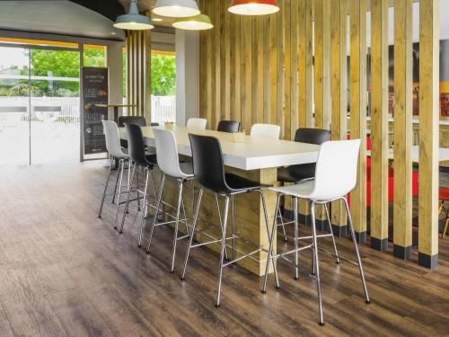 a conference room with a white table and chairs at ibis Tarbes Odos in Odos