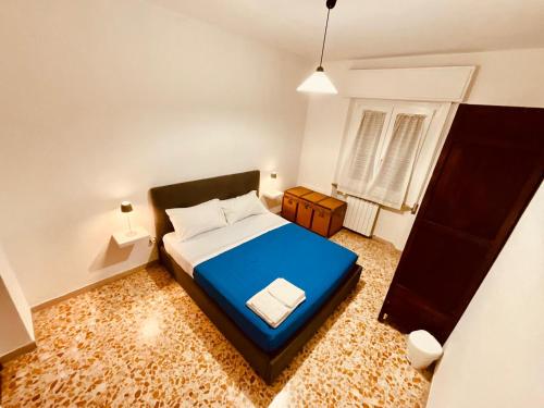 a small bedroom with a blue bed and a window at La Residenza dell'Arrotino in Capitan Loreto