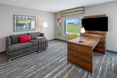 a living room with a couch and a flat screen tv at Hampton Inn Sheridan in Sheridan