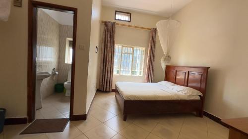 a bedroom with a bed and a bathroom at Karibu motel mbale in Mbale