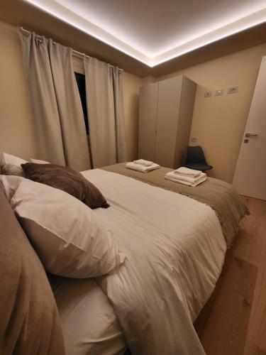a bedroom with two beds with pillows and a window at La Dimora delle Nevi in Aosta