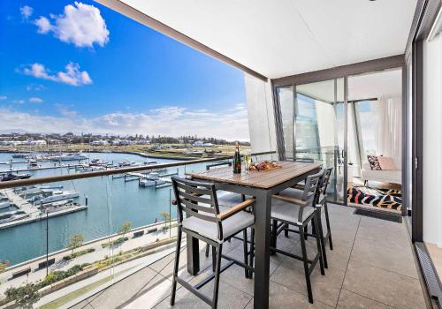 a dining room with a view of a marina at The Marina Outlook - Elevated Views in Shellharbour