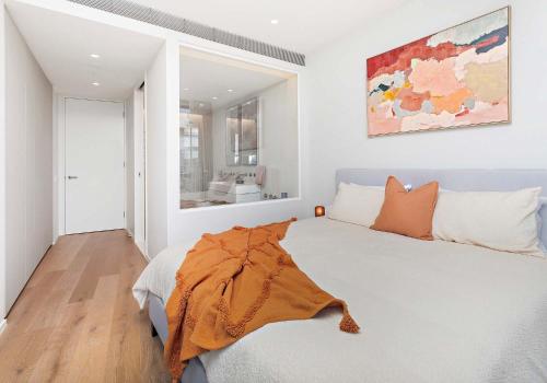 a bedroom with a bed and a painting on the wall at The Marina Outlook - Elevated Views in Shellharbour