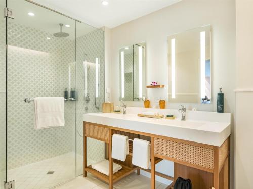 a bathroom with a sink and a shower at Hilton Hotel Tahiti in Papeete