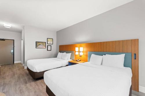 two beds in a hotel room with white sheets at Country Inn & Suites Etown in Elizabethtown