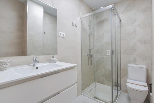 a bathroom with a shower and a sink and a toilet at Modern Loft in Málaga in Málaga