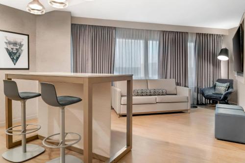 a living room with a table and a couch at Radisson Plaza Hotel at Kalamazoo Center in Kalamazoo