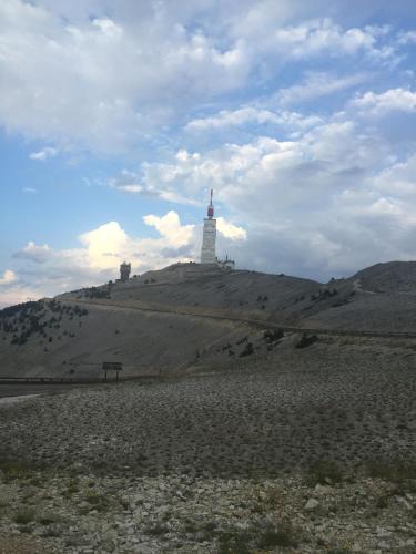a lighthouse on top of a hill with a sky at Le Signoret in Sault-de-Vaucluse
