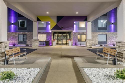 a lobby of a building with benches and purple at Spark by Hilton La Crosse Onalaska in Onalaska