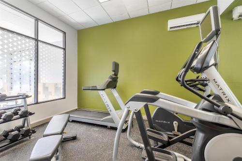 a gym with green walls and a treadmill at Spark by Hilton La Crosse Onalaska in Onalaska