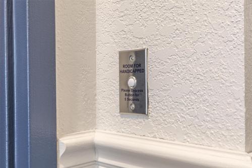a lightswitch on a wall with a sign on it at Spark by Hilton La Crosse Onalaska in Onalaska