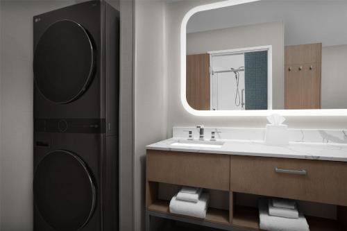 a bathroom with a sink and a mirror at Homewood Suites by Hilton Santa Maria in Santa Maria
