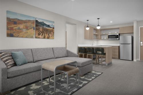 a living room with a couch and a kitchen at Homewood Suites by Hilton Santa Maria in Santa Maria