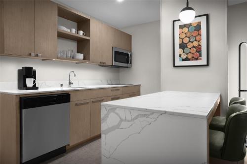 a kitchen with a white counter and a sink at Homewood Suites by Hilton Santa Maria in Santa Maria