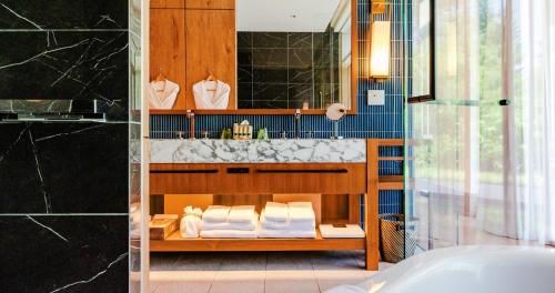 a bathroom with a sink and a counter with towels at UMITO Okinawa Onnason in Onna