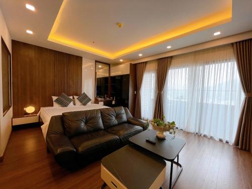 a large hotel room with a bed and a couch at FLC Sea Tower Quy Nhơn- View Biển in Quy Nhon