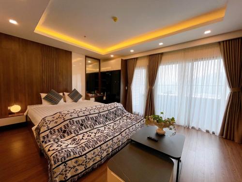 a bedroom with a large bed and a window at FLC Sea Tower Quy Nhơn- View Biển in Quy Nhon