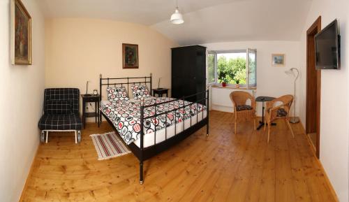 a bedroom with a bed and a table and chairs at Penzionek JH in Jindrichuv Hradec