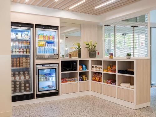 a kitchen with an open refrigerator with drinks at Novotel Suites Montpellier Antigone in Montpellier