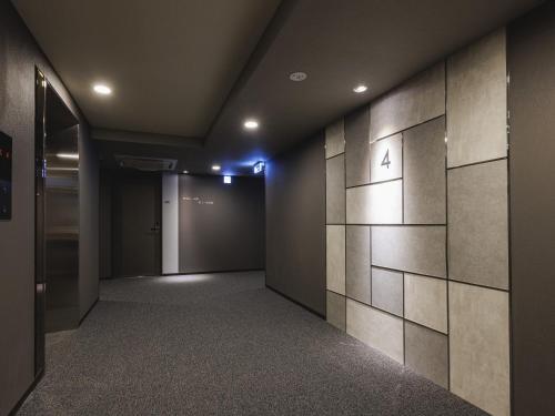 a hallway with a wall with the number four on it at Hotel Route Inn Kyoto Kumiyama in Kyoto
