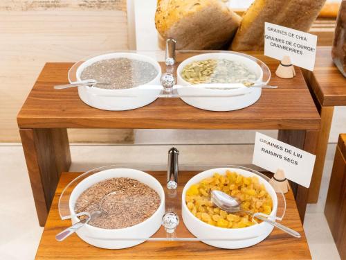 a display of bowls of food on a table at Novotel Suites Montpellier Antigone in Montpellier