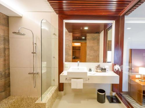 a bathroom with a sink and a shower at Novotel Nha Trang in Nha Trang