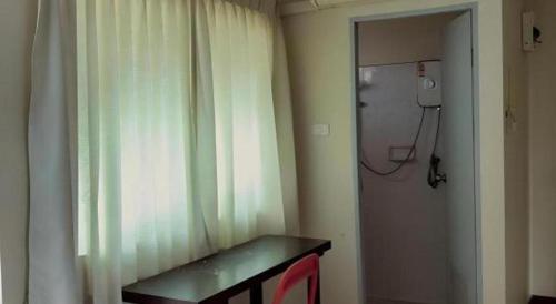 a room with a window with a curtain and a mirror at Huern Che Ta One Hotel in Phrae