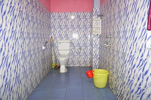 a bathroom with a toilet and two buckets at Entire 1BHK & 2BHK private apartments with personal kitchen, 767ooo54oo, TAJ RESIDENCY Holiday Homestay in Jorhat