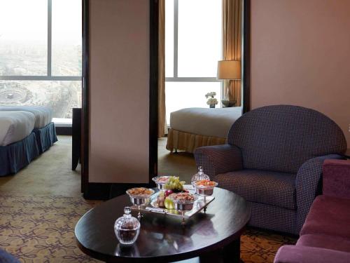 a hotel room with a tray of food on a table at Pullman ZamZam Makkah in Makkah