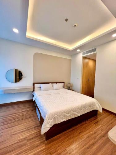 a bedroom with a large bed and a mirror at FLC Sea Tower Quy Nhơn- View Biển in Quy Nhon