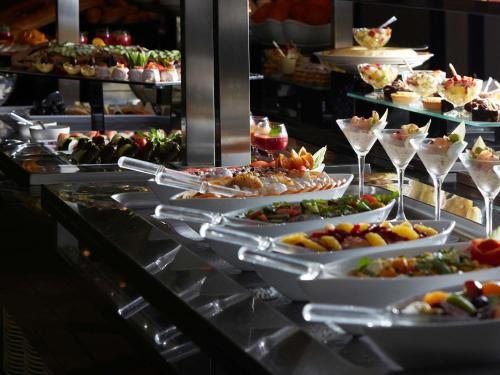 a buffet line with many plates of food on display at Pullman ZamZam Makkah in Makkah
