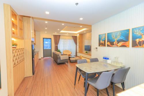 a dining room and living room with a table and chairs at FLC Sea Tower Quy Nhơn- View Biển in Quy Nhon