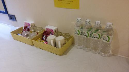 a group of bottles of water sitting on a counter at Banana Resort Sadao in Sadao