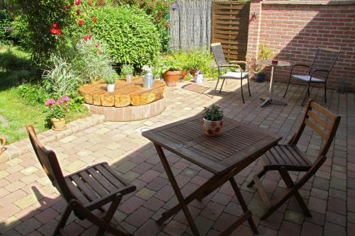 a patio with a table and two chairs and a potted plant at Penzionek JH in Jindrichuv Hradec