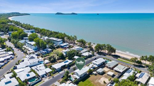 an aerial view of a beach with houses and the ocean at Belle Escapes Beachside Oasis in Palm Cove