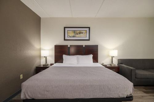 a hotel room with a bed and a chair at Quality Inn & Suites Lexington South in Lexington