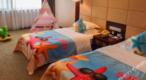 a bedroom with two beds and a toy tent at Huangshan International Hotel in Huangshan